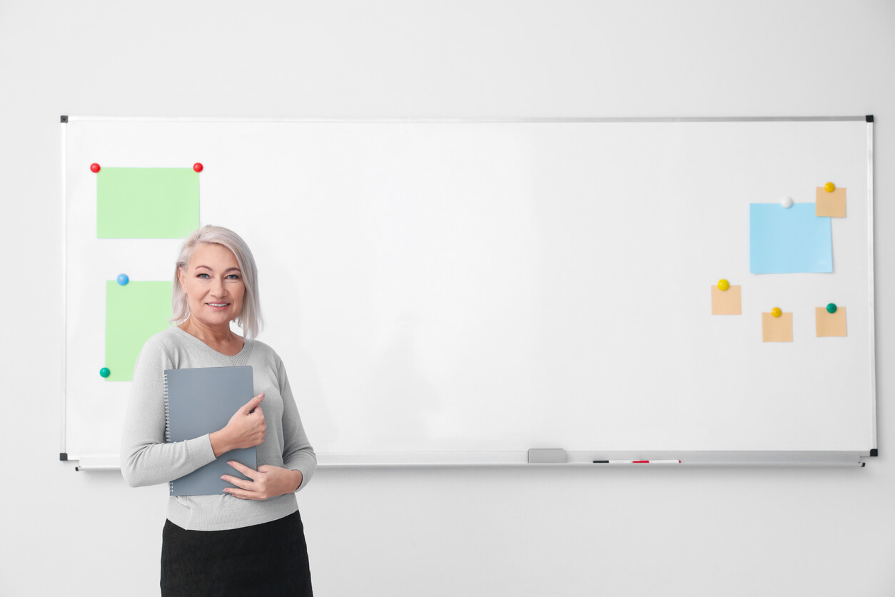 UX certification- a master practitioner poses at whiteboard